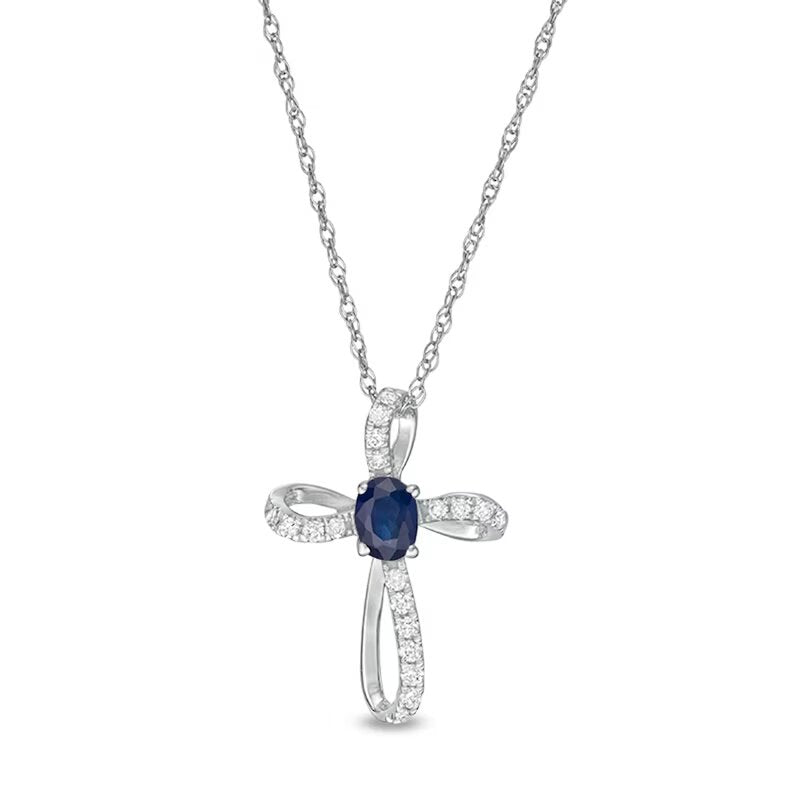 Oval Blue Sapphire and 1/10 CT. T.W. Diamond Pinwheel Cross Pendant in 10K White Gold